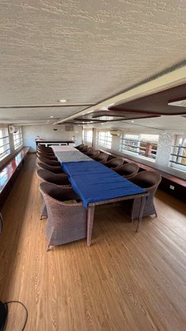The long dining table on the upper deck, with a serving counter at the far end