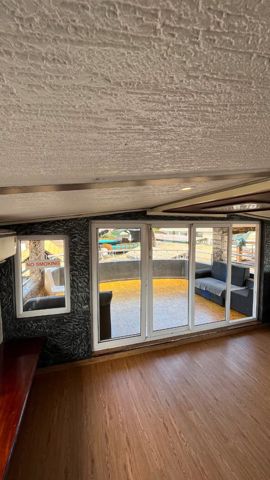 Glass doors opening from the upper hall onto the open deck
