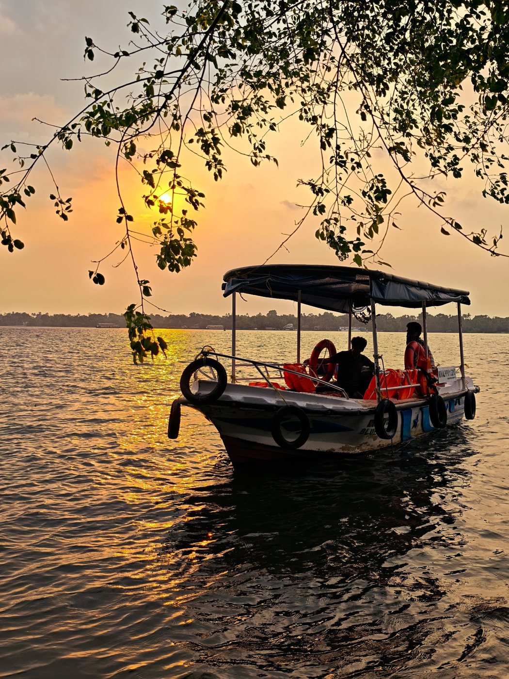 Our covered slow boat on the lake at sunset